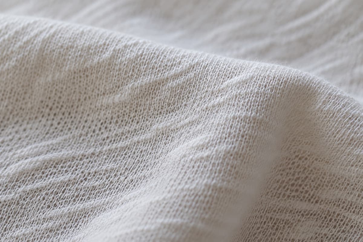 ภาพประกอบผ้า Cotton Slub (ผ้าผสม) ซูมใกล้ให้เห็นลายถักของผ้ายืด